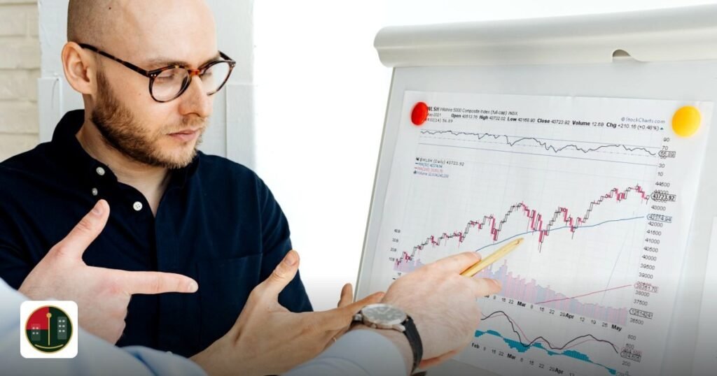 DIFC vs ADGM FinTech licensing: 2026 comparison - business professionals discussing financial graphs on a flipchart during