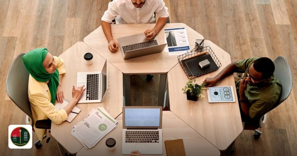 Choosing the Best UAE Free Zone for E-commerce - top view of diverse coworkers collaborating at a modern office table